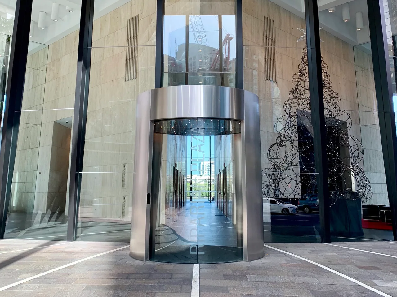 The Eagle Street entrance to Riparian Plaza: the revolving door under the glass foyer.